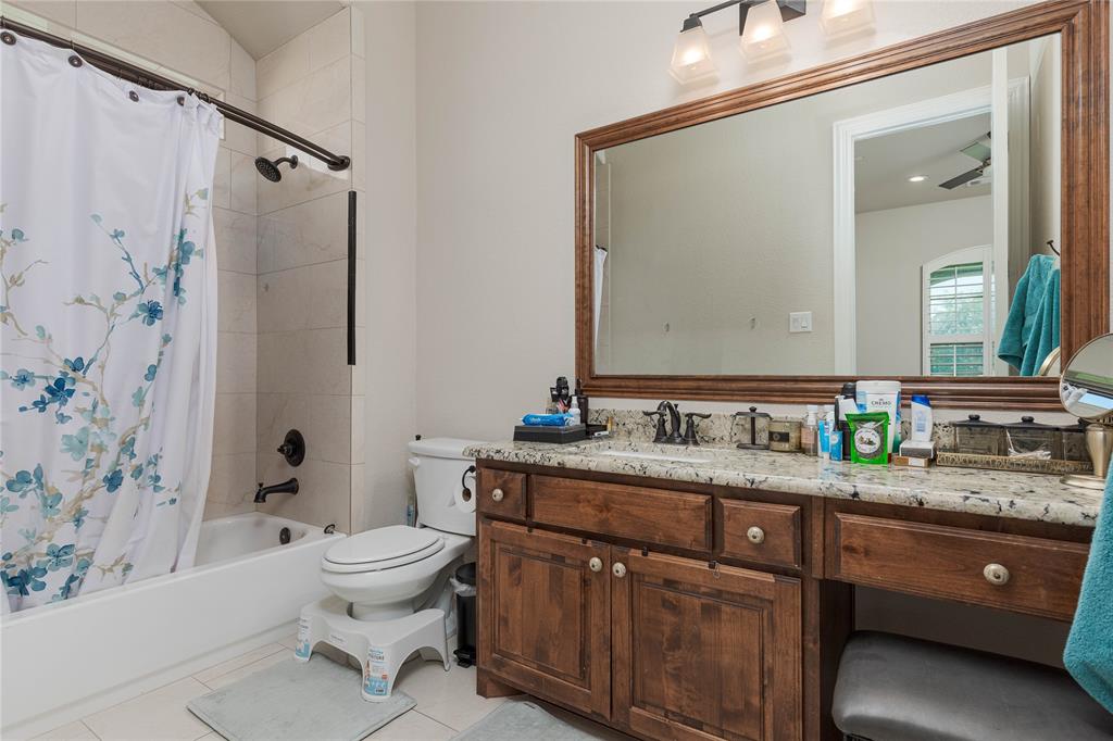 835 Bentwater Lucas, TX 75002 - Photo 22 of 40 a bathroom with a granite countertop sink a toilet and a bathtub