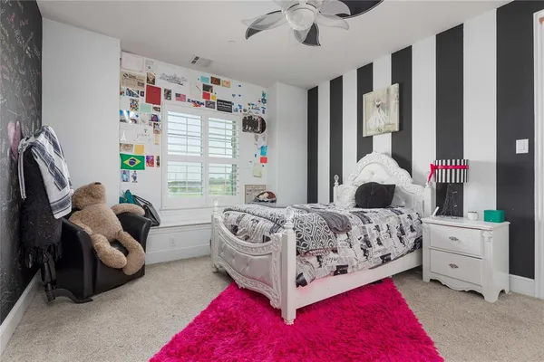 a bedroom with a bed couch and window