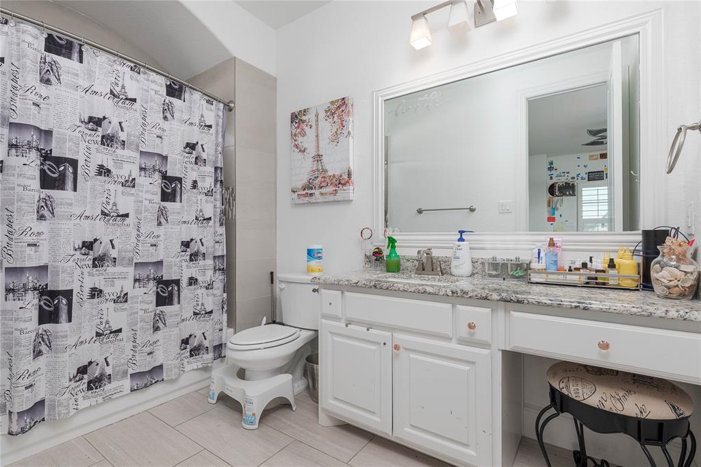 835 Bentwater Lucas, TX 75002 - Photo 24 of 40 a bathroom with a granite countertop toilet a sink a mirror a window and a shower