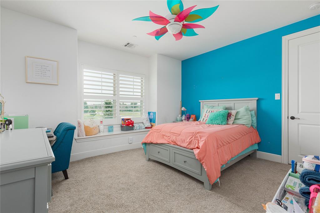 835 Bentwater Lucas, TX 75002 - Photo 29 of 40 a bedroom with a bed and a chandelier