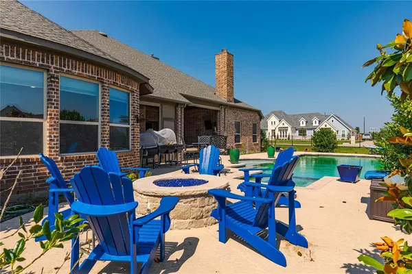 a view of a chairs and table in patio