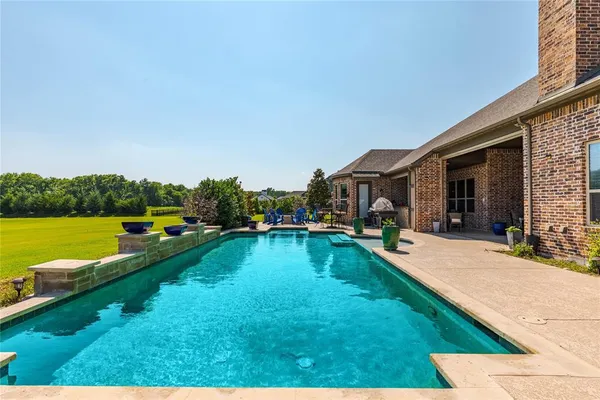 a view of a house with swimming pool and porch with furniture