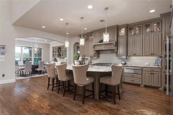 a large kitchen with a table and chairs