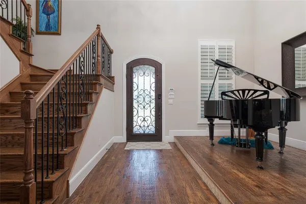 a view of entryway with wooden floor and stairs