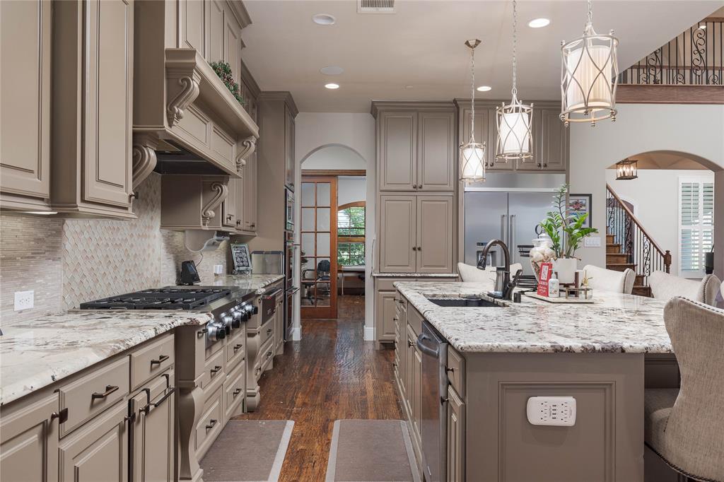 835 Bentwater Lucas, TX 75002 - Photo 9 of 40 a kitchen with granite countertop a sink stove and cabinets