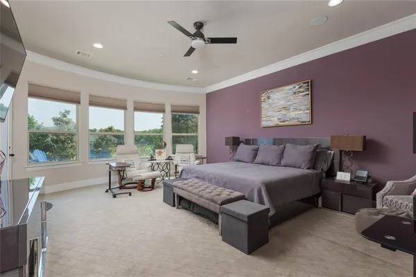 a spacious bedroom with a bed and large windows