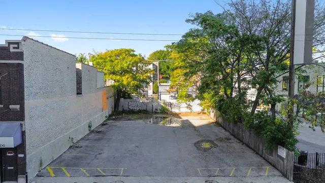 a view of a pathway with a fountain in front of a house