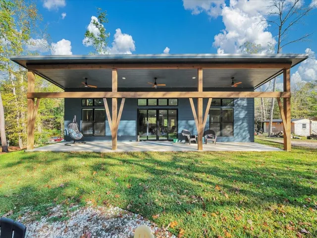 a view of a house with sitting area and a yard