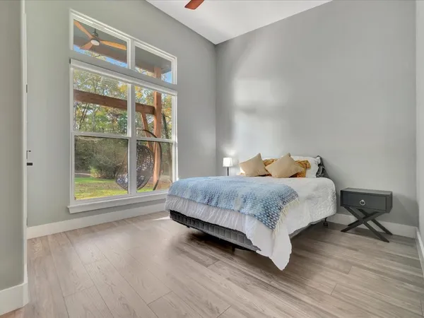 a bedroom with a bed and wooden floor