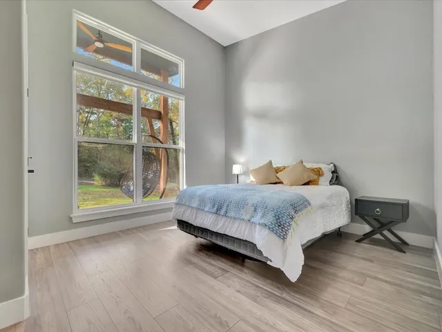 a bedroom with a bed and wooden floor