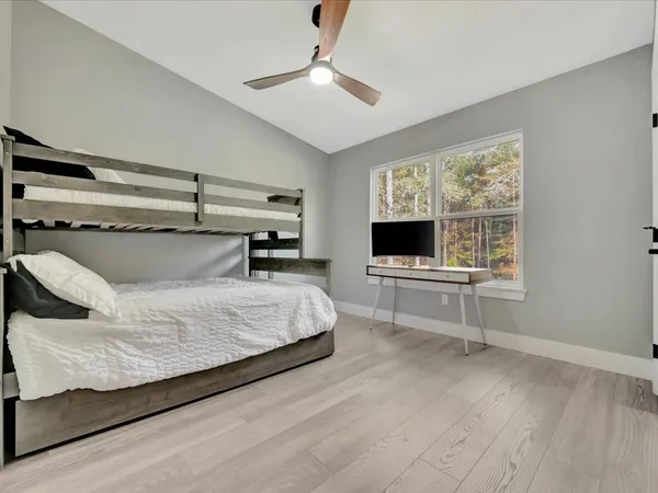 a bedroom with a bed and flat screen tv