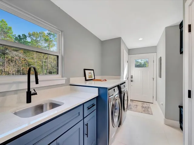 a kitchen with stainless steel appliances a sink and a refrigerator