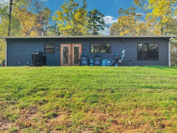 a view of a back yard of the house with green space