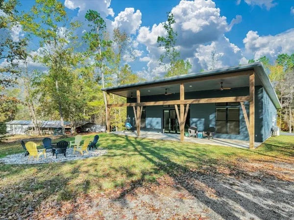 a view of a chair and table in the patio next to a yard