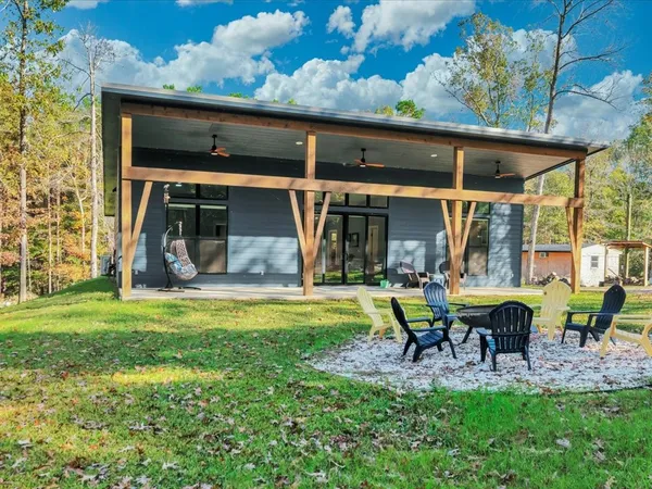 a view of a house with backyard sitting area and garden