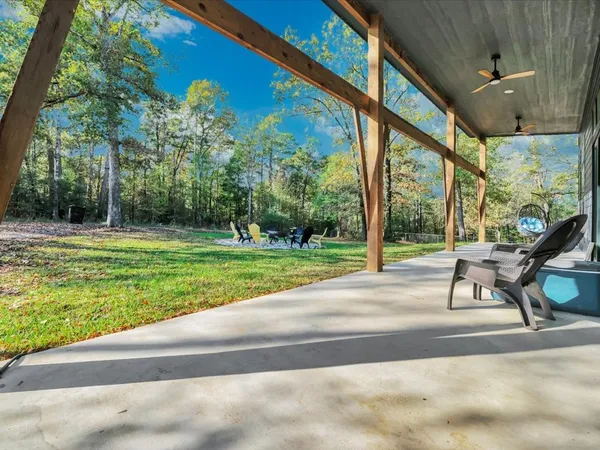 a swimming pool with lawn chairs yard and outdoor seating