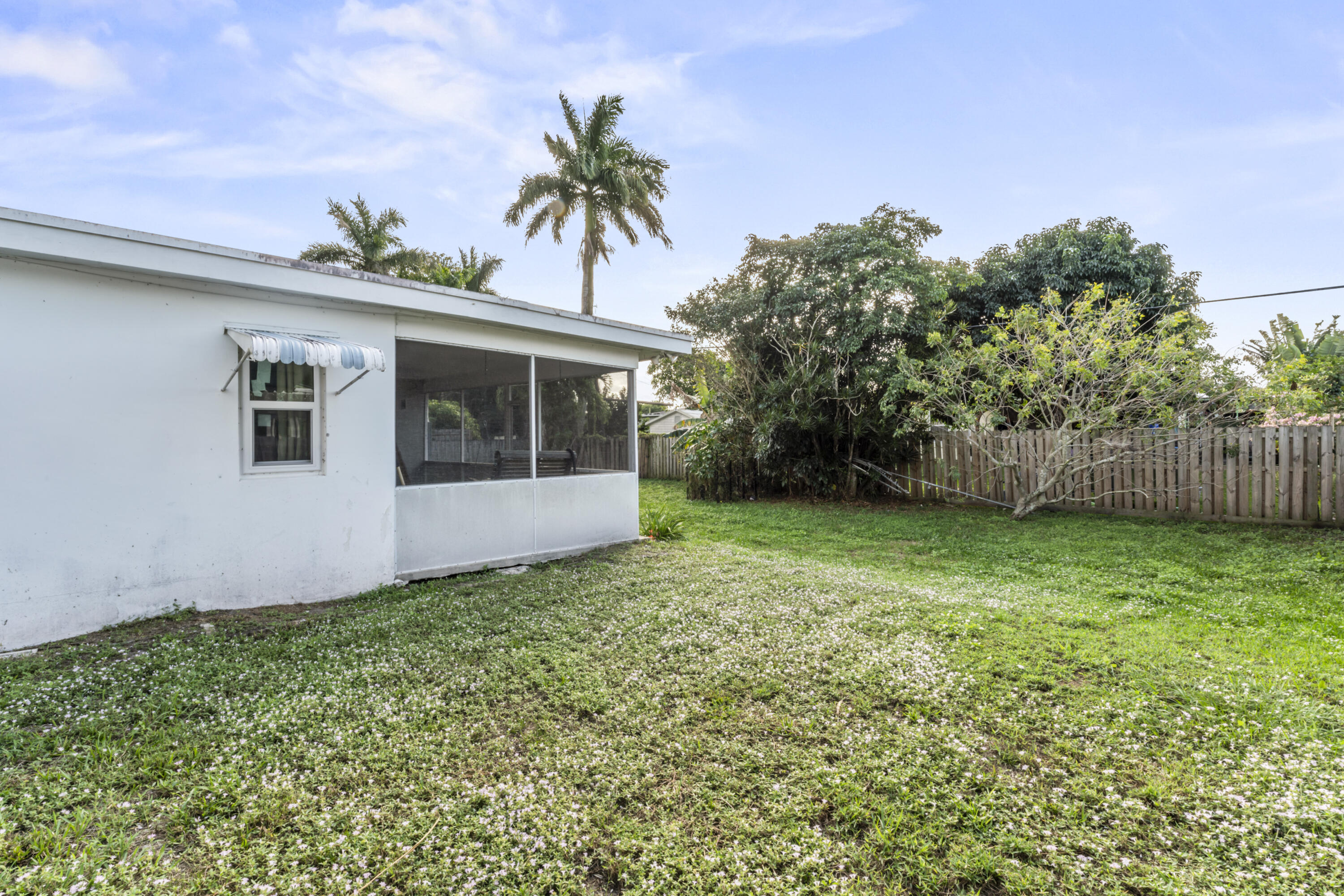 337 East Lake Road Palm Springs, FL 33461 - Photo 16 of 26 a view of a house with a yard