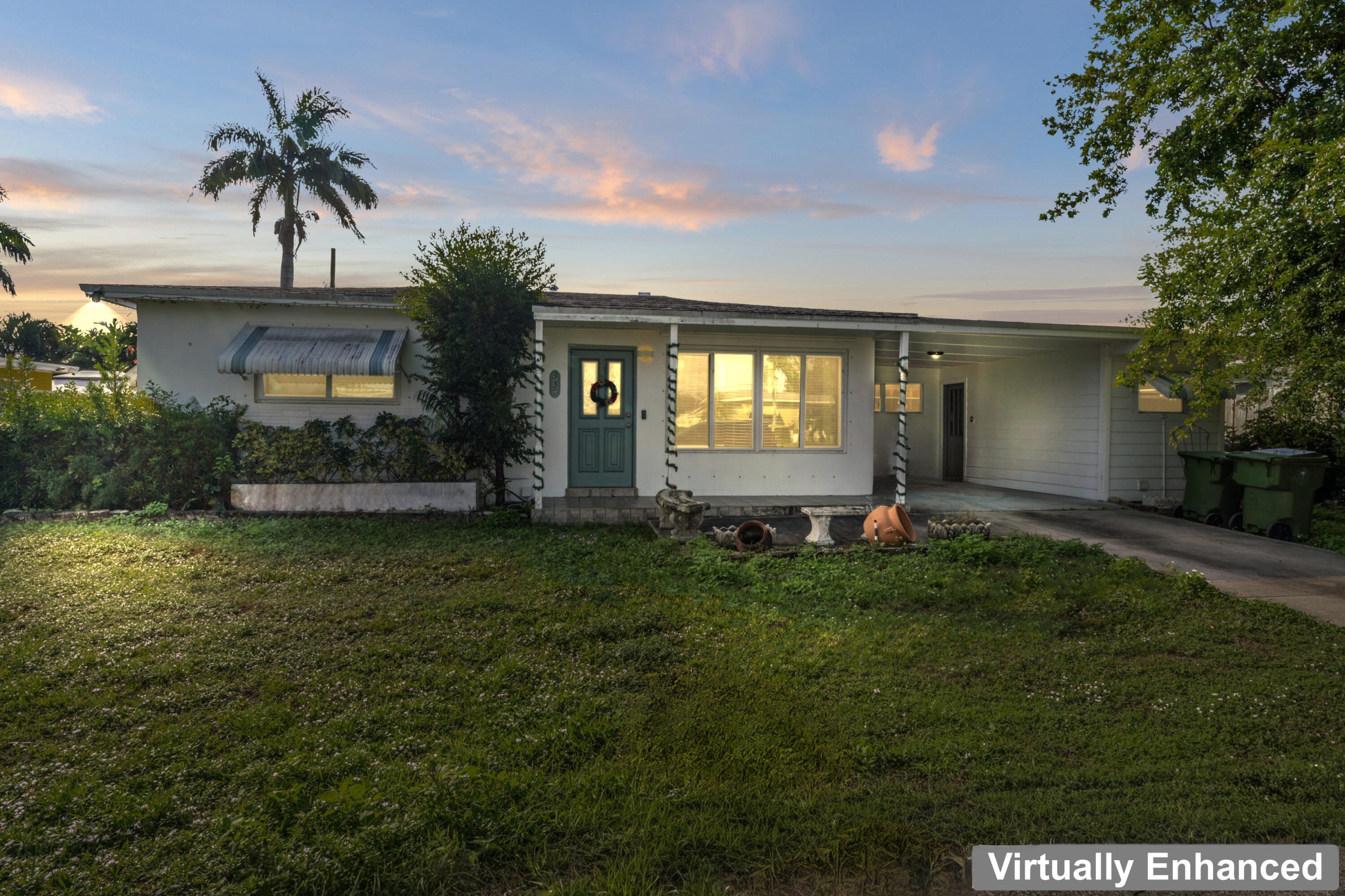 337 East Lake Road Palm Springs, FL 33461 - Photo 23 of 26 a front view of a house with a garden and yard