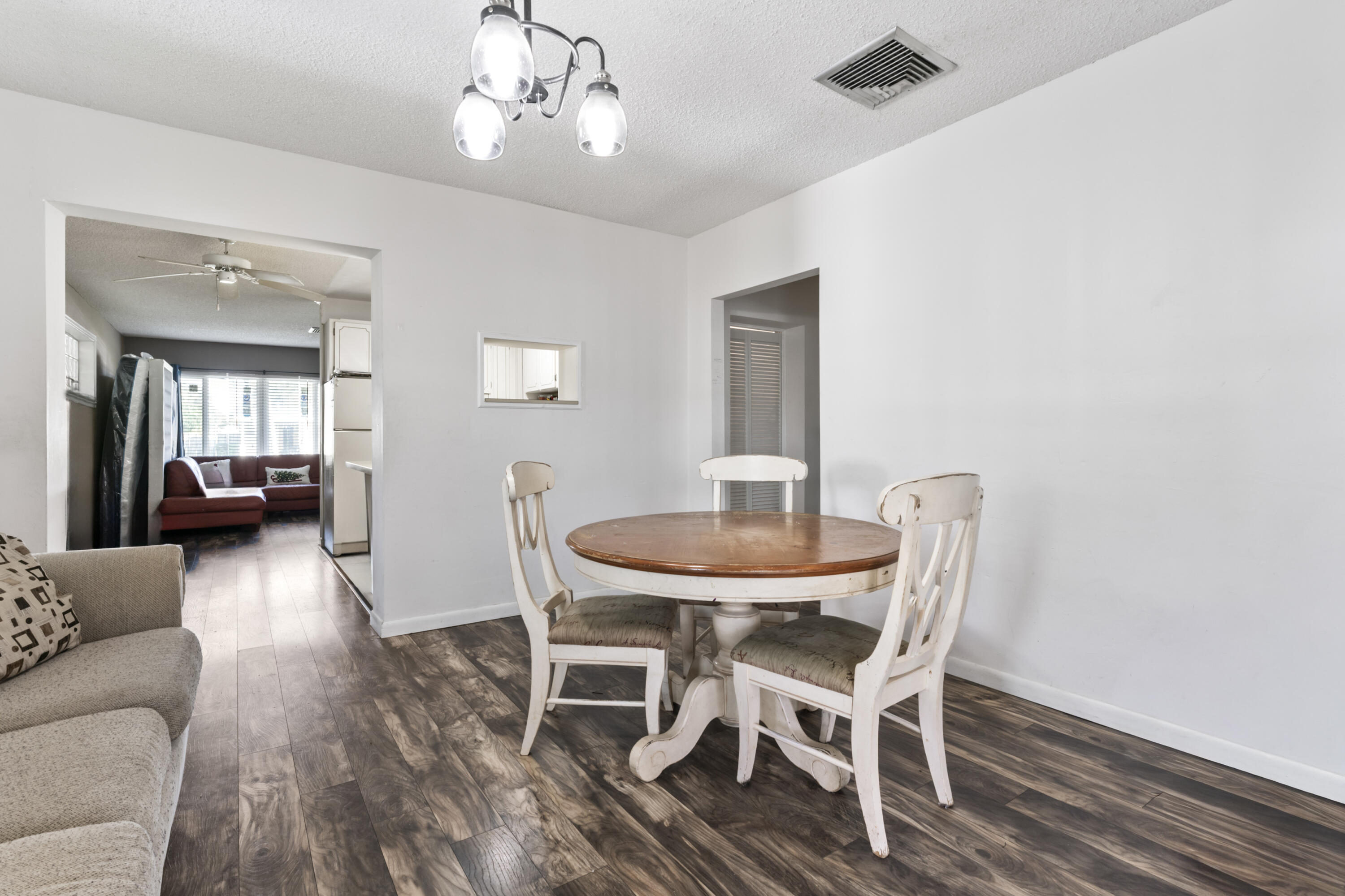 337 East Lake Road Palm Springs, FL 33461 - Photo 7 of 26 a view of a dining room with furniture and wooden floor