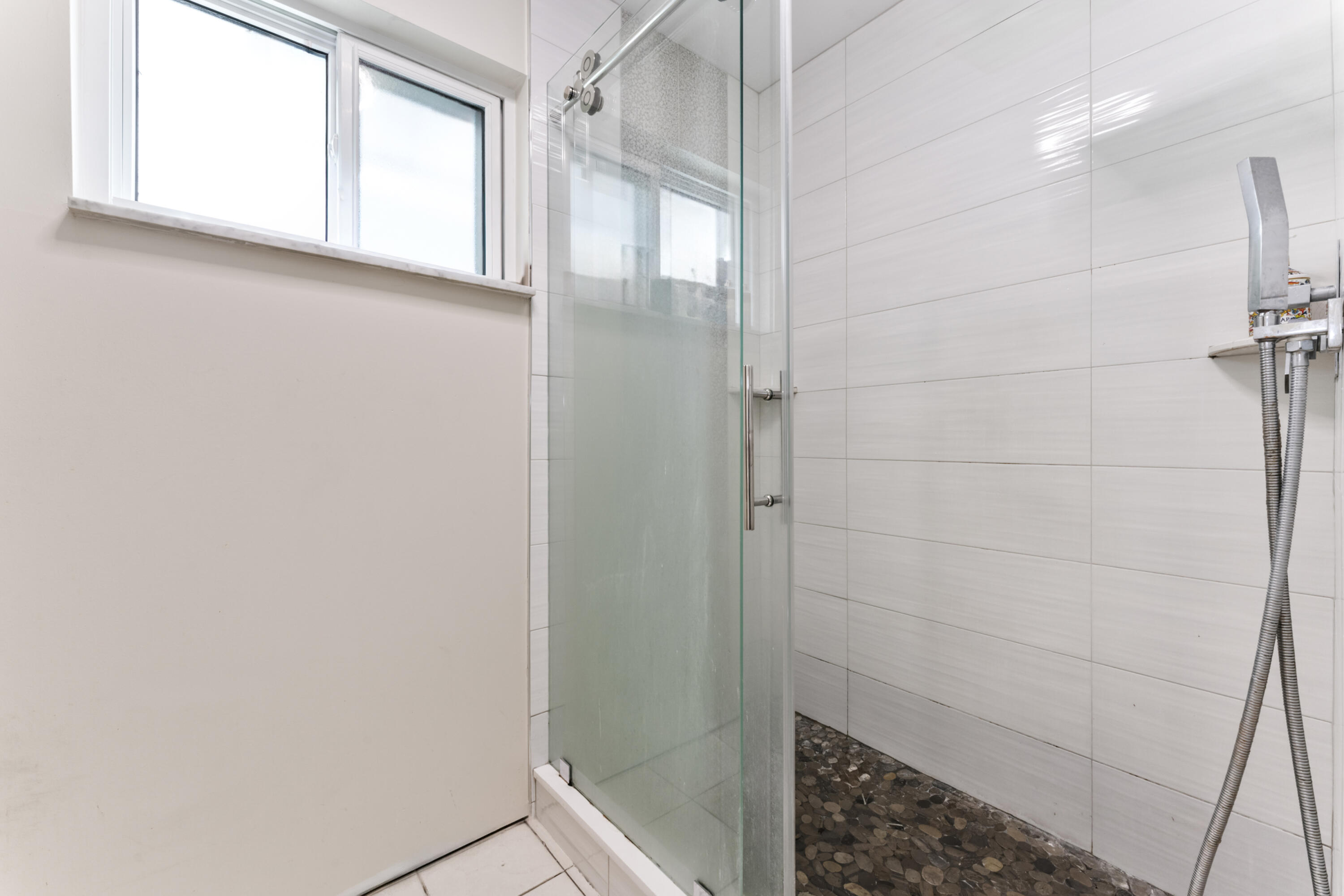 337 East Lake Road Palm Springs, FL 33461 - Photo 9 of 26 a bathroom with a glass shower door