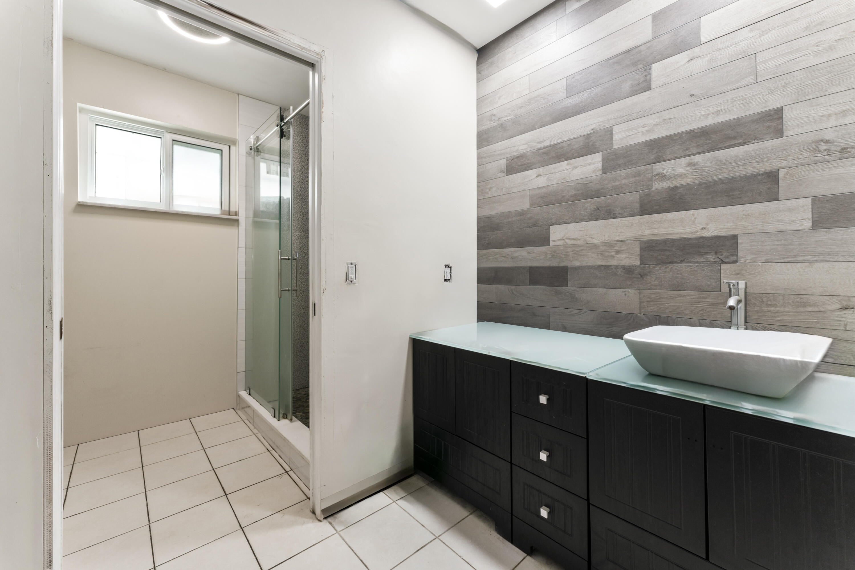 337 East Lake Road Palm Springs, FL 33461 - Photo 10 of 26 a bathroom with a sink a mirror and shower