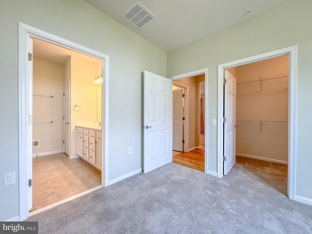 an empty room with closet and a bathroom