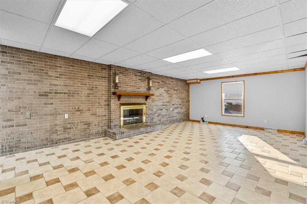 5610 Fleming Terrace Road Greensboro, NC 27410 - Photo 24 of 50 Great room in the basement with a fireplace