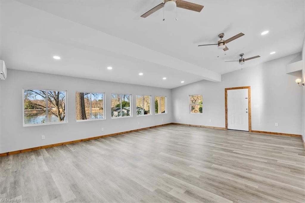 5610 Fleming Terrace Road Greensboro, NC 27410 - Photo 27 of 50 Amazing bonus room with wall of windows looking out on the lake