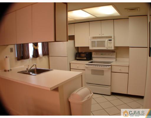 272 B Convent Road Monroe Township, NJ 08831 - Photo 5 of 10 a kitchen with a sink appliances and cabinets