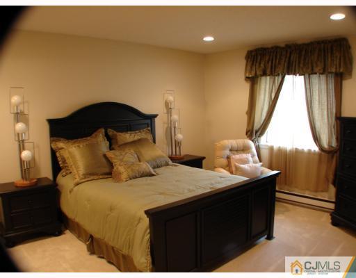272 B Convent Road Monroe Township, NJ 08831 - Photo 7 of 10 a bedroom with a bed and a window