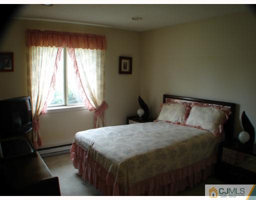 272 B Convent Road Monroe Township, NJ 08831 - Photo 8 of 10 a bedroom with a bed and a window