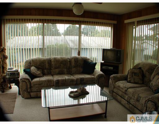 272 B Convent Road Monroe Township, NJ 08831 - Photo 9 of 10 a living room with furniture and a flat screen tv