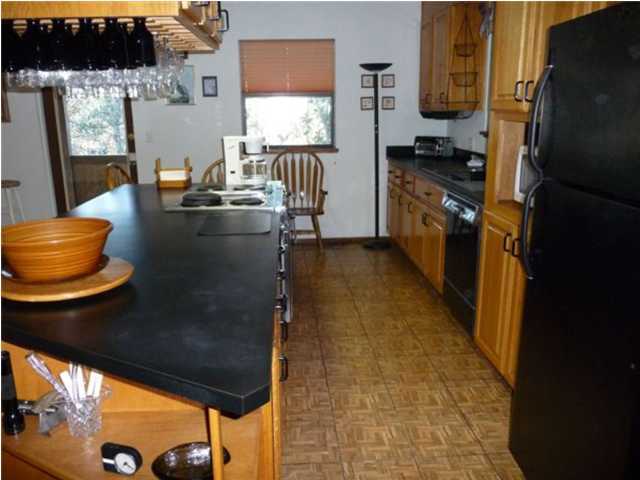 813 Blue Mountain Road Santa Rosa Beach, FL 32459 - Photo 8 of 19 a kitchen with a sink and a refrigerator