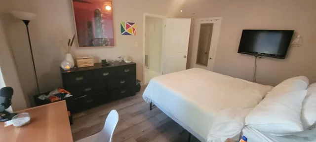 a bedroom with a bed and a flat screen tv