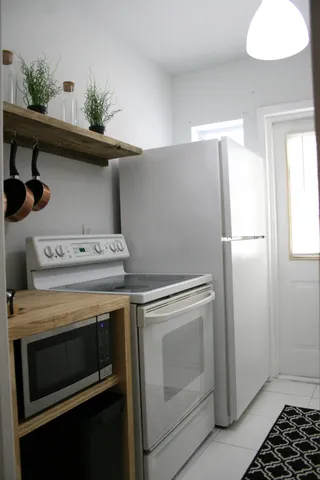 a stove top oven sitting inside of a kitchen