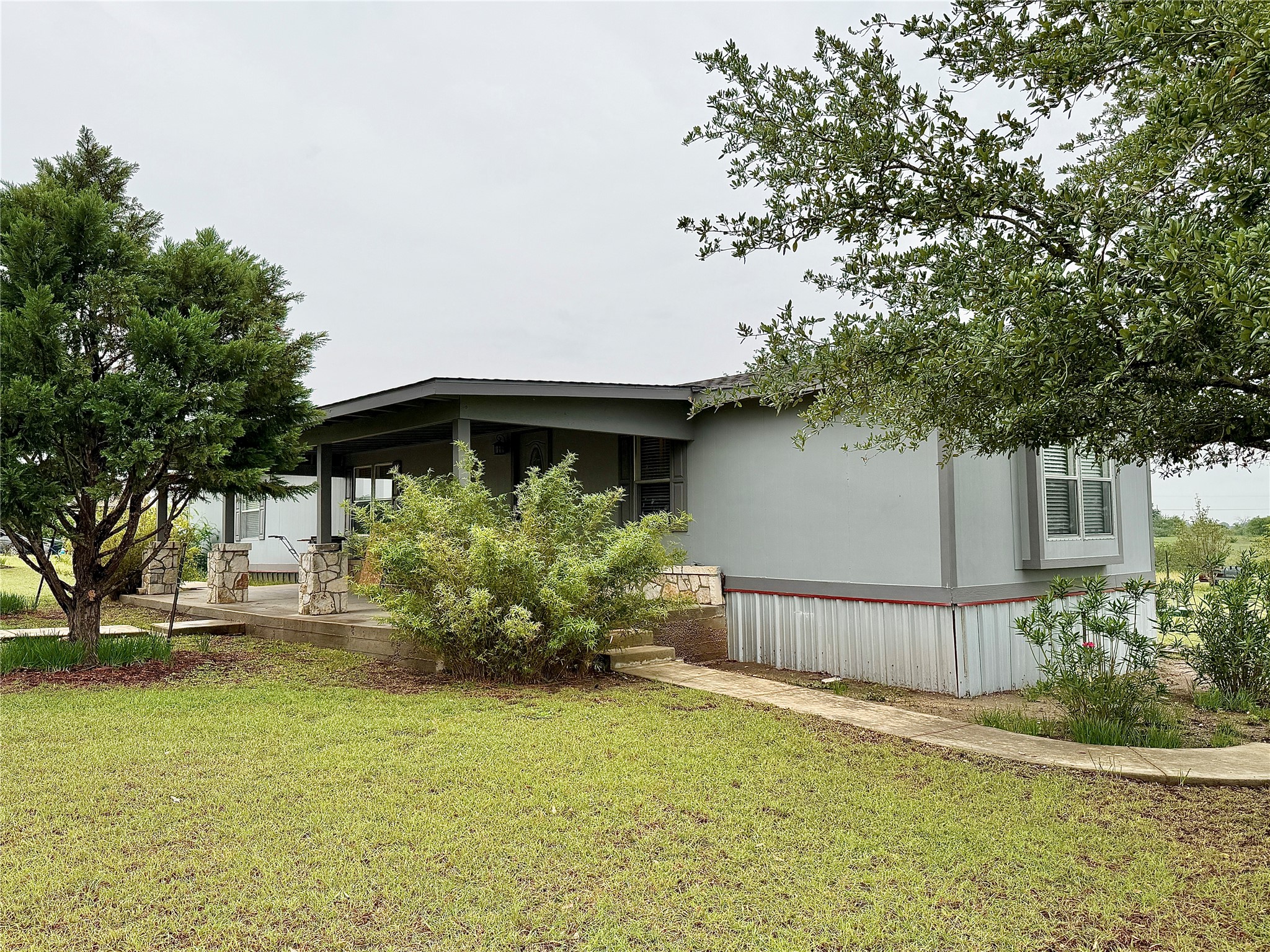 3075 FM 2001 Buda, TX 78610 - Photo 26 of 26 A welcoming front porch with stone accents creates an inviting entry.