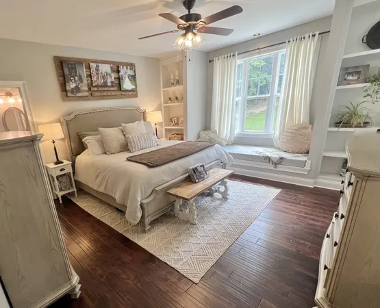 a bedroom with a bed and glass walk in closet