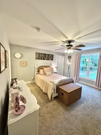 a bed room with furniture and a window