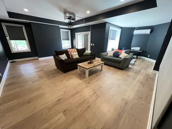 a living room with furniture and a wooden floor