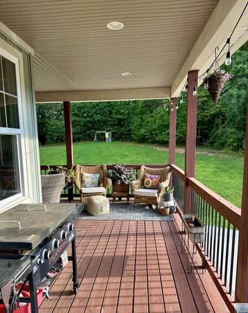 a view of a patio with dining table and chairs