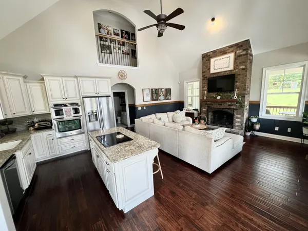a living room with furniture fireplace and flat screen tv