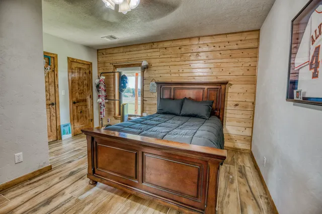 a spacious bedroom with a bed next to a window