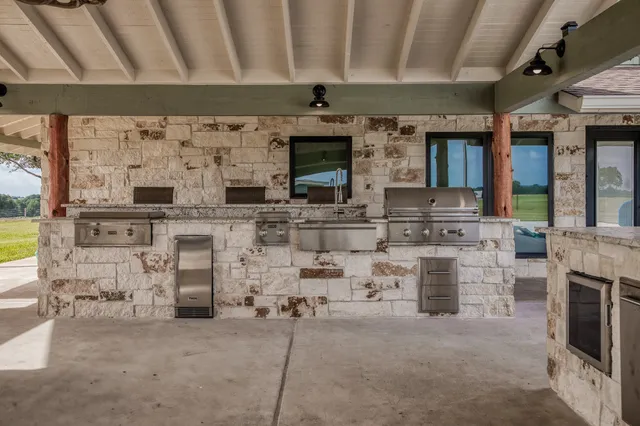 a view of a house with a swimming pool and sitting area