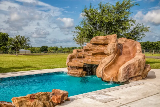 a view of house that has a big yard