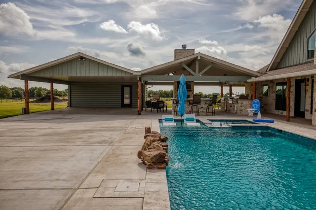 a view of a house with a yard and sitting area