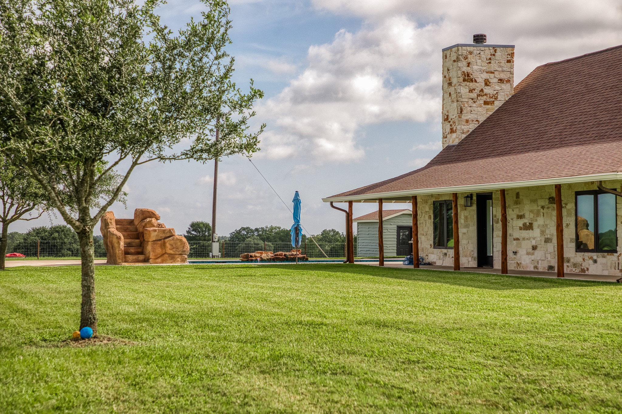 18581 William Penn Road Washington, TX 77880 - Photo 4 of 49 a view of a white house with a big yard and large trees