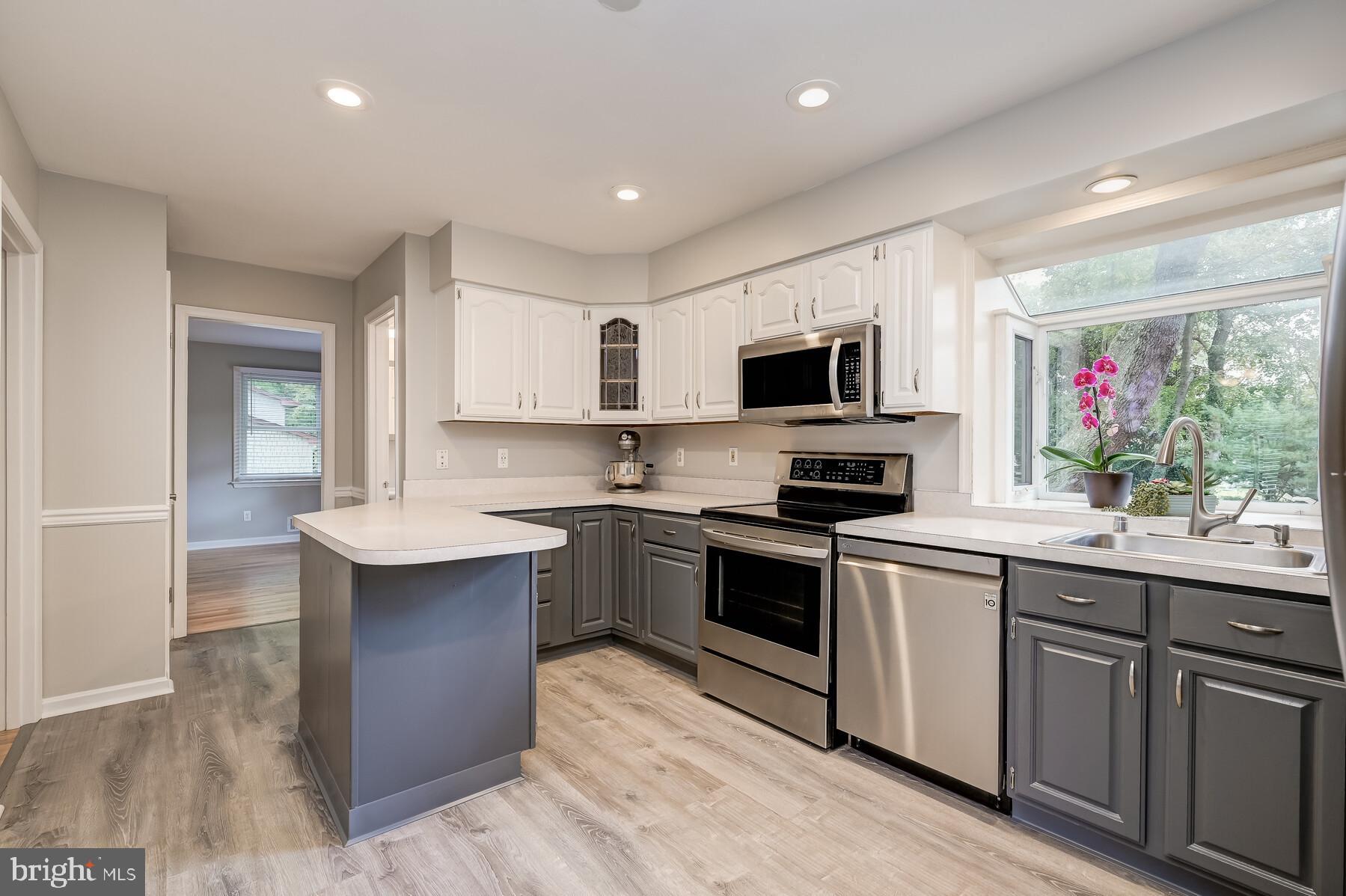 Kitchen with SS appliances and Vinyl Plank floors