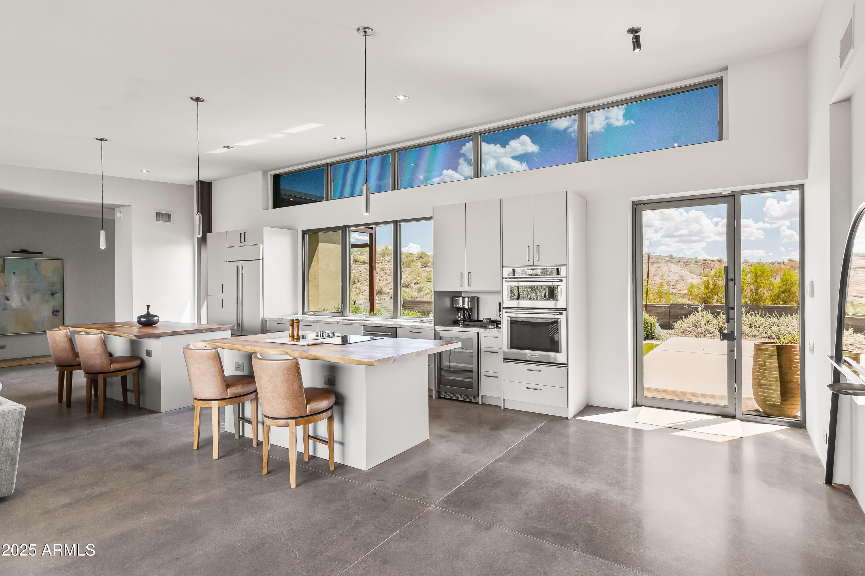 15310 North Sandy Bluff Road Fort McDowell, AZ 85264 - Photo 26 of 53 a large white kitchen with a large window and stainless steel appliances