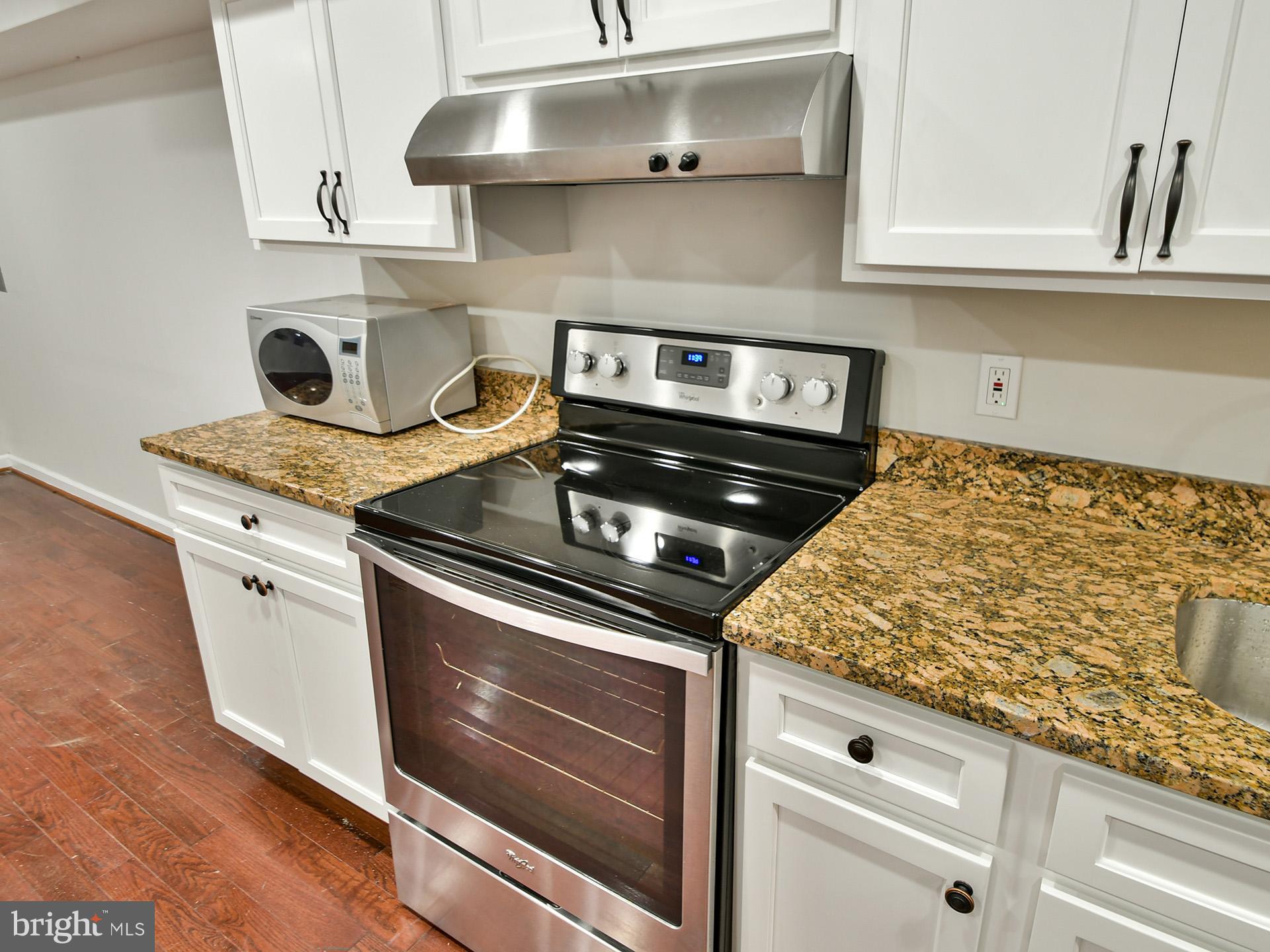 620 Irving Street Northwest, Unit 2 Washington, DC 20010 - Photo 14 of 26 a stove top oven sitting inside of a kitchen