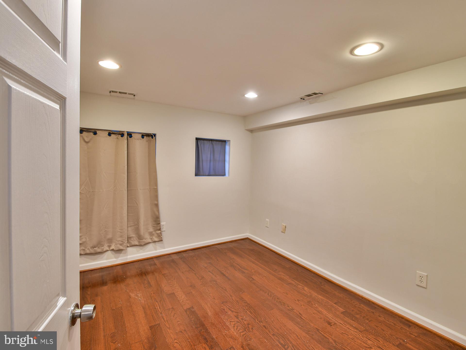 620 Irving Street Northwest, Unit 2 Washington, DC 20010 - Photo 16 of 26 a view of empty room with wooden floor